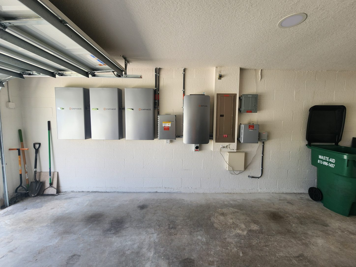 Enphase IQ Battery installation in a Florida garage — three batteries wired into the main panel